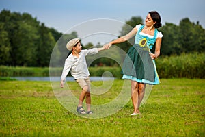 Attractive young woman in a dirndl with her son