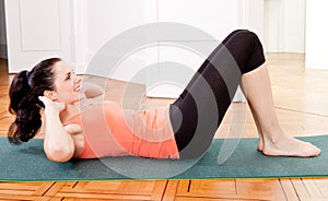 Attractive young woman doing sit ups