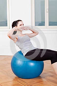 Attractive young woman doing sit ups