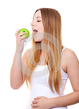 Attractive young woman eating apple