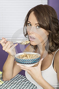 Attractive Young Woman Eating Breakfast Cereal