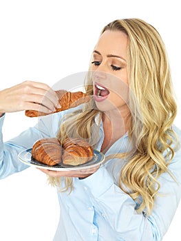 Attractive Young Woman Eating a Freshly Baked Danish Pastries
