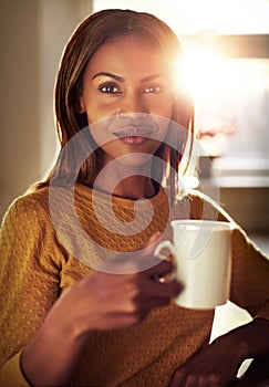 Attractive young woman enjoying a cup of coffee