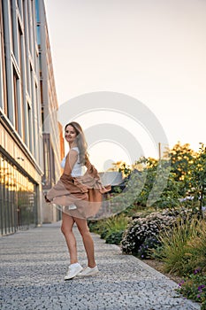 Attractive young woman enjoying her free time at sunset outdoor. Happy girl portrait at summer. Freedom lifestyle summer