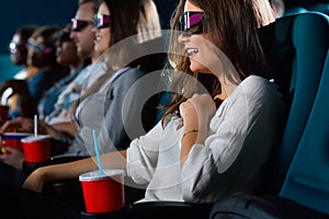 Attractive young woman enjoying movies at the cinema