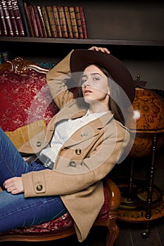 Attractive young woman in fashionable coat and hat