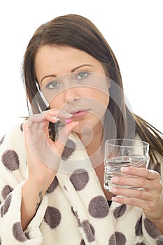 Attractive Young Woman Feeling Hungover and Unwell Taking Medicine photo