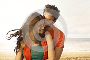 Attractive young woman getting a kiss at beach photo