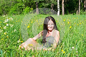 Attractive young woman on green grass