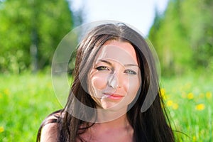 Attractive young woman on green grass