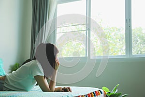 Attractive young woman happy look on the way to windows on bed in room morning