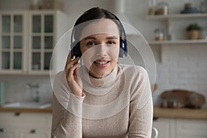 Attractive young woman in headphones take part in videoconference photo