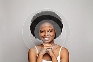 Attractive young woman with healthy clean skin looking at camera isolated on studio background. Facial treatment and skincare