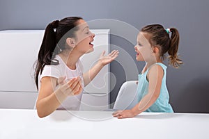 Speech Therapist Helps The Girl To Pronounce The Sounds photo