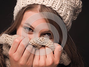 Attractive young woman hiding her face with a scarf