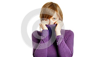 Attractive young woman hiding in the turtleneck