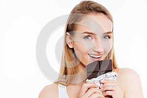 Attractive young woman holding chocolate bar