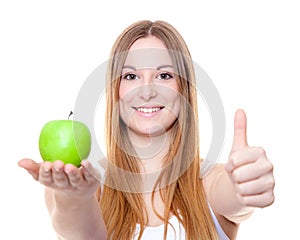 Attractive young woman holding green apple