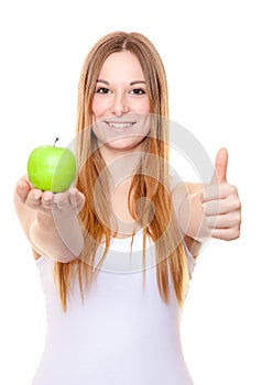 Attractive young woman holding green apple