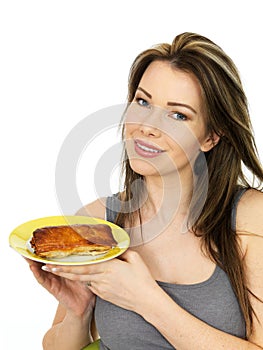 Attractive Young Woman Holding A Large Sausage Roll on a Plate