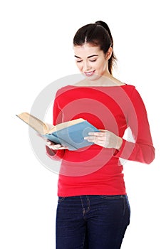 Attractive young woman holding open book,reading.