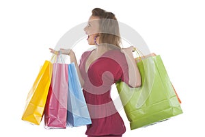 Attractive young woman holding several shoppingba
