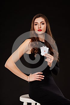 Attractive young woman holding the winning combination of poker cards