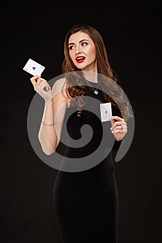 Attractive young woman holding the winning combination of poker cards