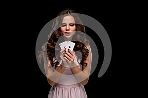 Attractive young woman holding the winning combination of poker cards