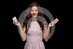 Attractive young woman holding the winning combination of poker cards