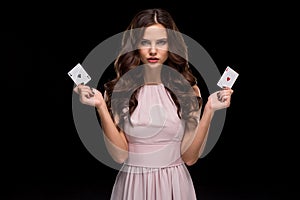 Attractive young woman holding the winning combination of poker cards