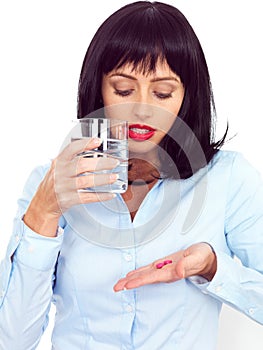 Attractive Young Woman Holing a Glass of Water and Two Tablets