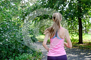 Attractive young woman jogging on park trail. healthy lifestyle concept