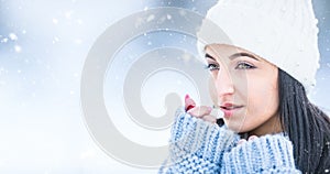 Attractive young woman l protecting lips with lip balm in snowy and frozen weather photo