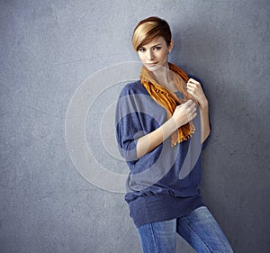 Attractive young woman leaning to wall