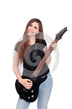 Attractive, young woman with long hair in blue jeans and a black t-shirt plays an electric guitar isolated on a white background