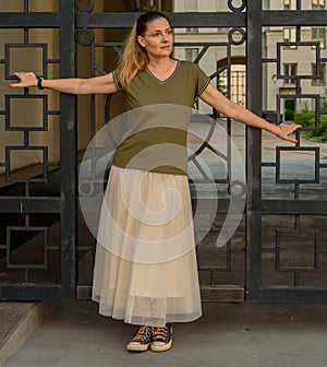 An attractive young woman with long hair, dressed in a T-shirt, looks away. A young blogger poses for his blog, content