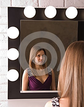 An attractive young woman looking in the mirror