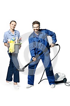 Attractive young woman and man in cleaning uniform and rubber gloves holding a broom cleaning products in his hands