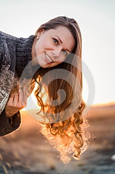 Attractive young woman outdoors at sunset