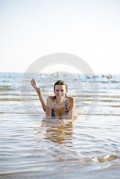 Attractive young woman paddling in the sea