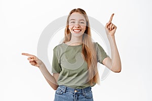 Attractive young woman with perfect smile, pointing fingers sideways, showing left and right banners, two choices, pick