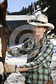 Attractive Young Woman Petting Horse