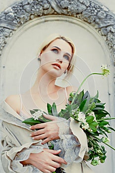 Woman holding bunch of wildflowers