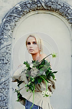 Woman holding bunch of wildflowers