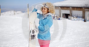 Attractive young woman posing at a ski resort