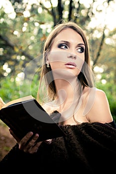 Attractive young woman reading book