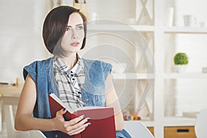 Attractive young woman reading book