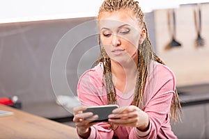 Attractive young woman reading a text message