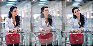 Attractive young woman with red bag in shopping center. Beautiful fashionable young lady with long hair in white male shirt